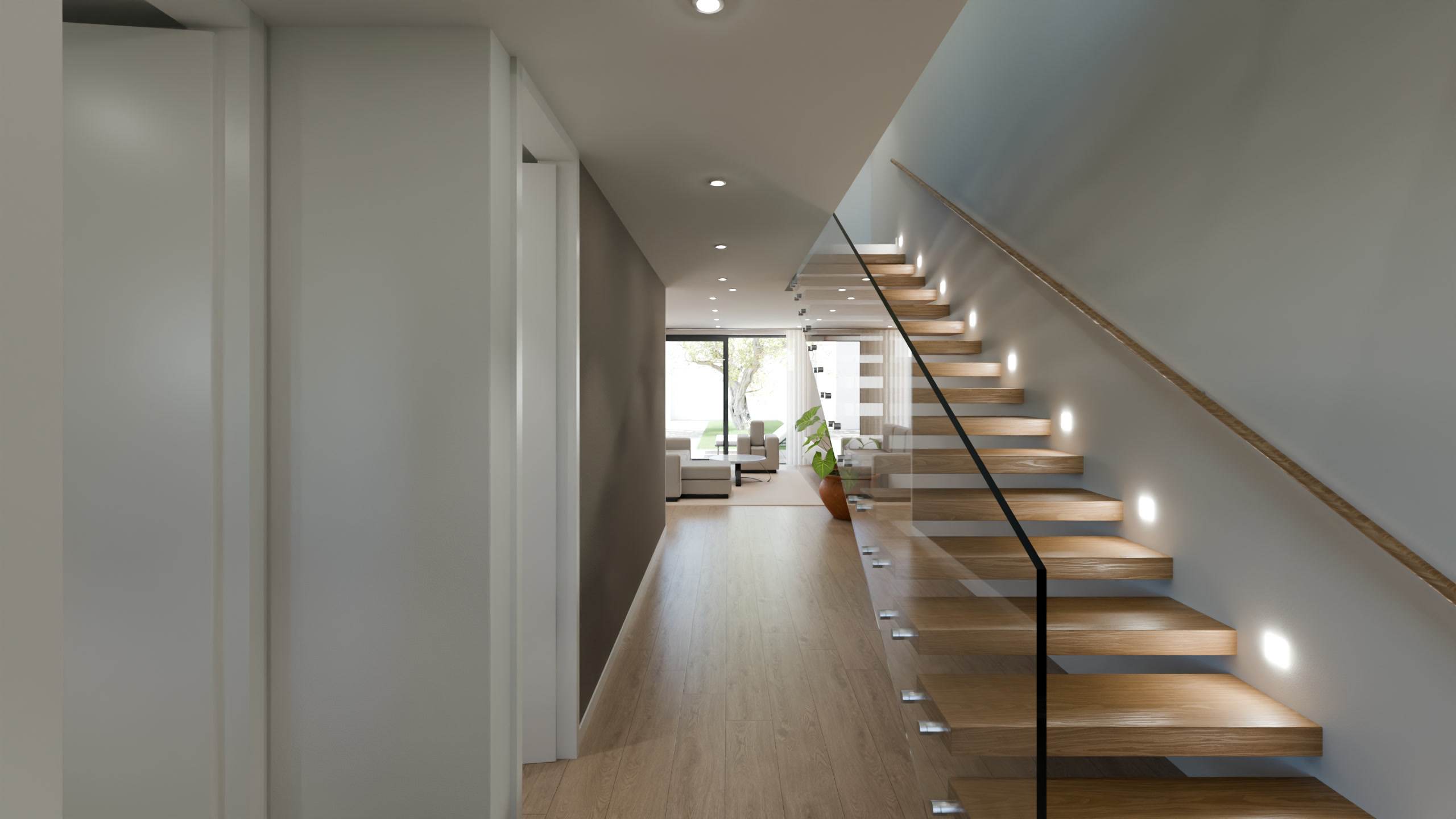 Hall da moradia T3 com a escada em balanço e corrimão de madeira.