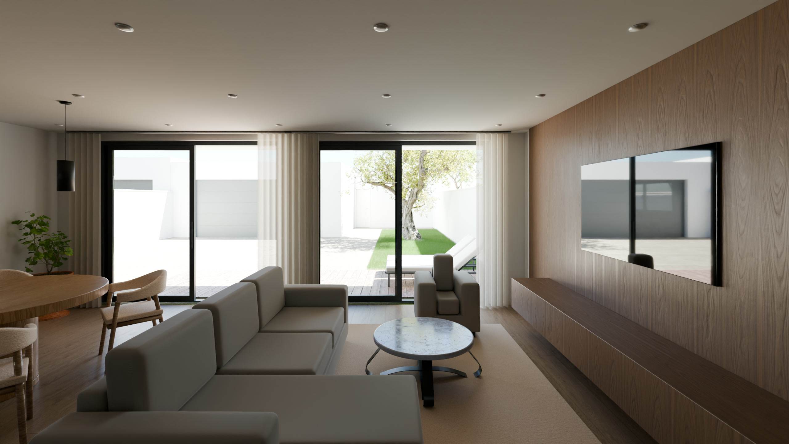 Sala da moradia T3 com sofá e porta de vidro para o pátio.